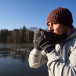 Adult caucasian man warming up before winter swimming