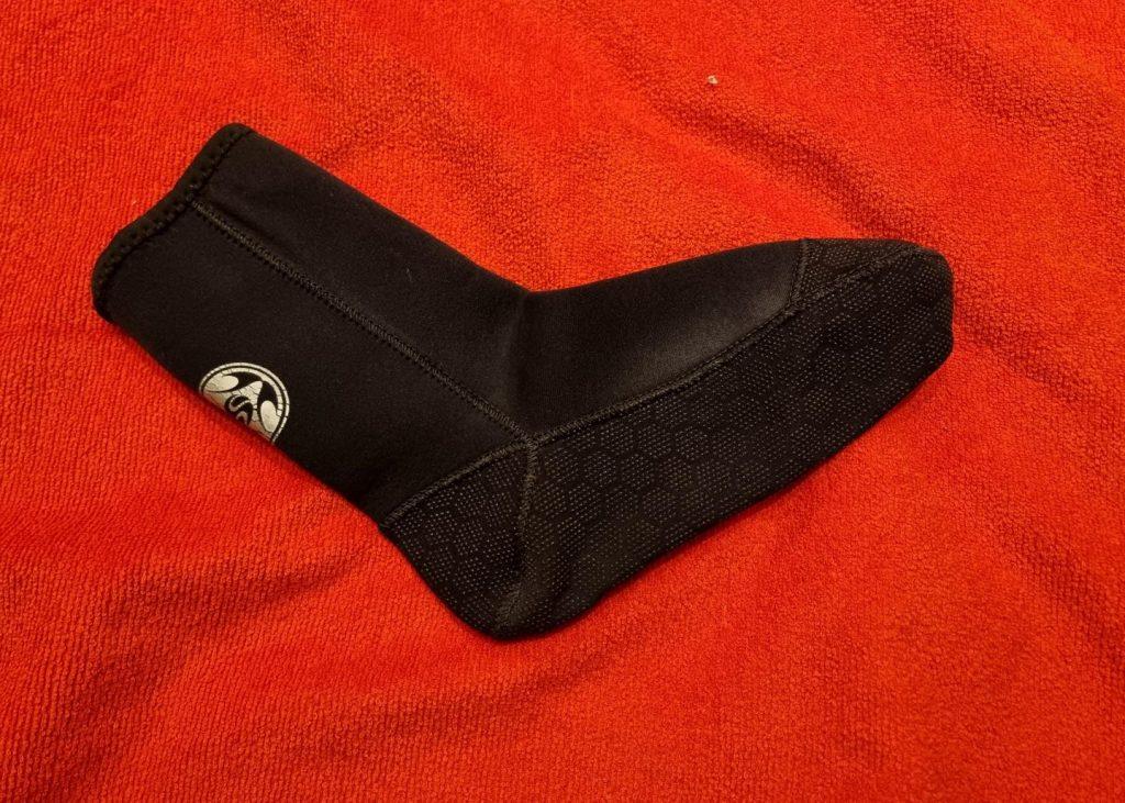 A neoprene sock on a red towel