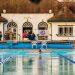 Someone swimming butterfly towards the camera in a lido