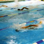 Swimmers racing in a pool