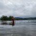 A woman walking out of a lake.