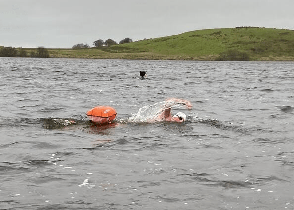 A man swimming in a lake